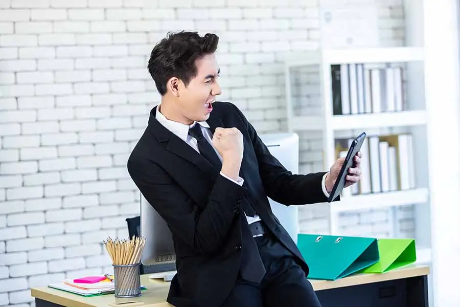 businessman celebrating success of Singapore PR application