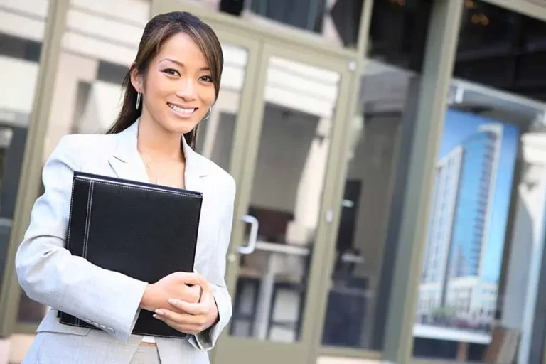 friendly singapore pr consultant standing in front of office building