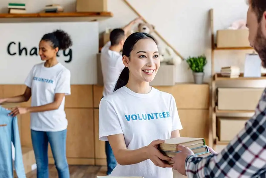 volunteers distributing books and clothes